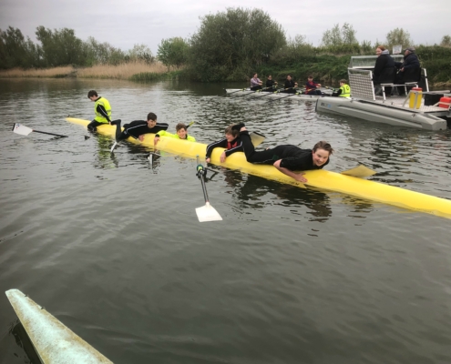 School pupils on upturned hull