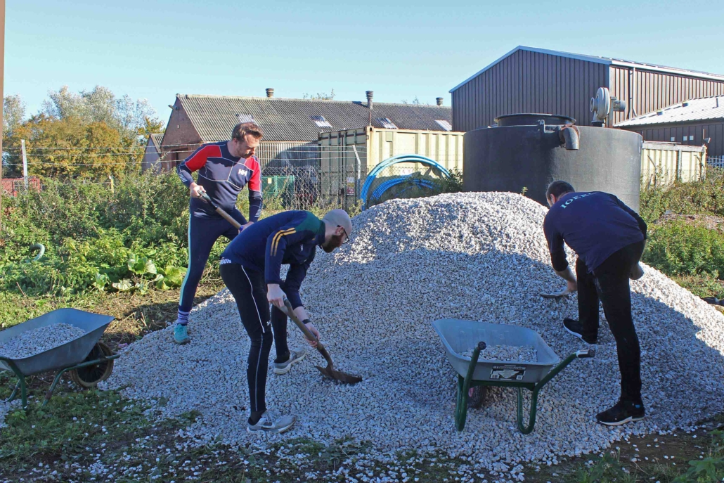DiggingChaps Shovelling hardcore into barrows