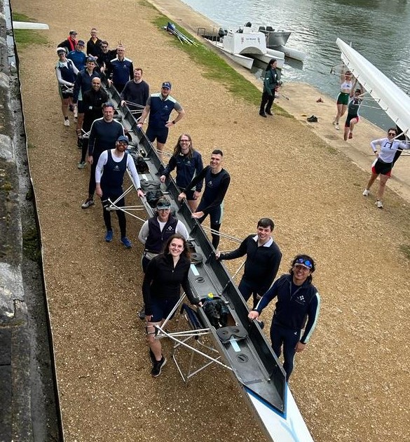Ely crews standing next to Filippi eight