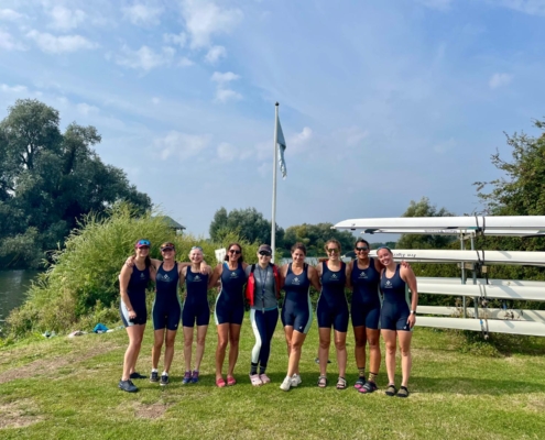 Women's eight standing on land at Isle of Ely Rowing Club
