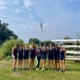 Women's eight standing on land at Isle of Ely Rowing Club