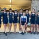 Women's eight crew on land, with willow in their hair