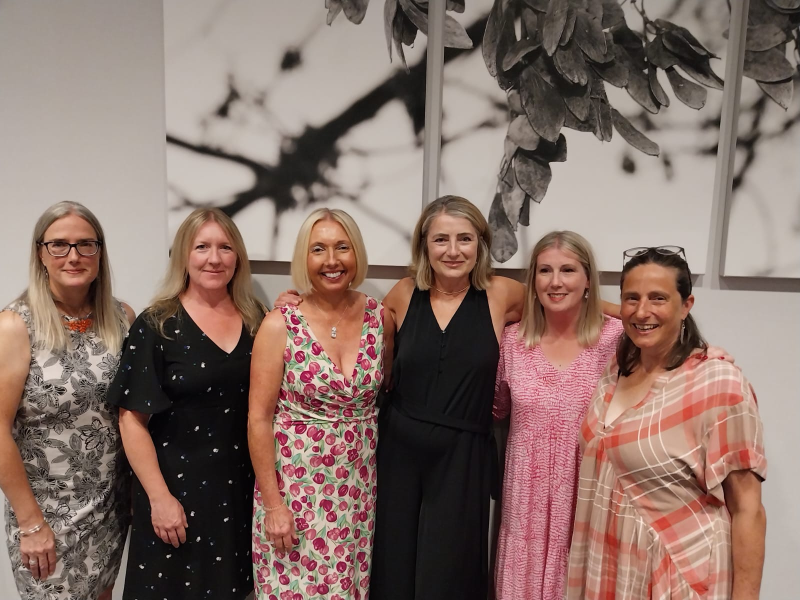 a group of five women dressed up for evening out